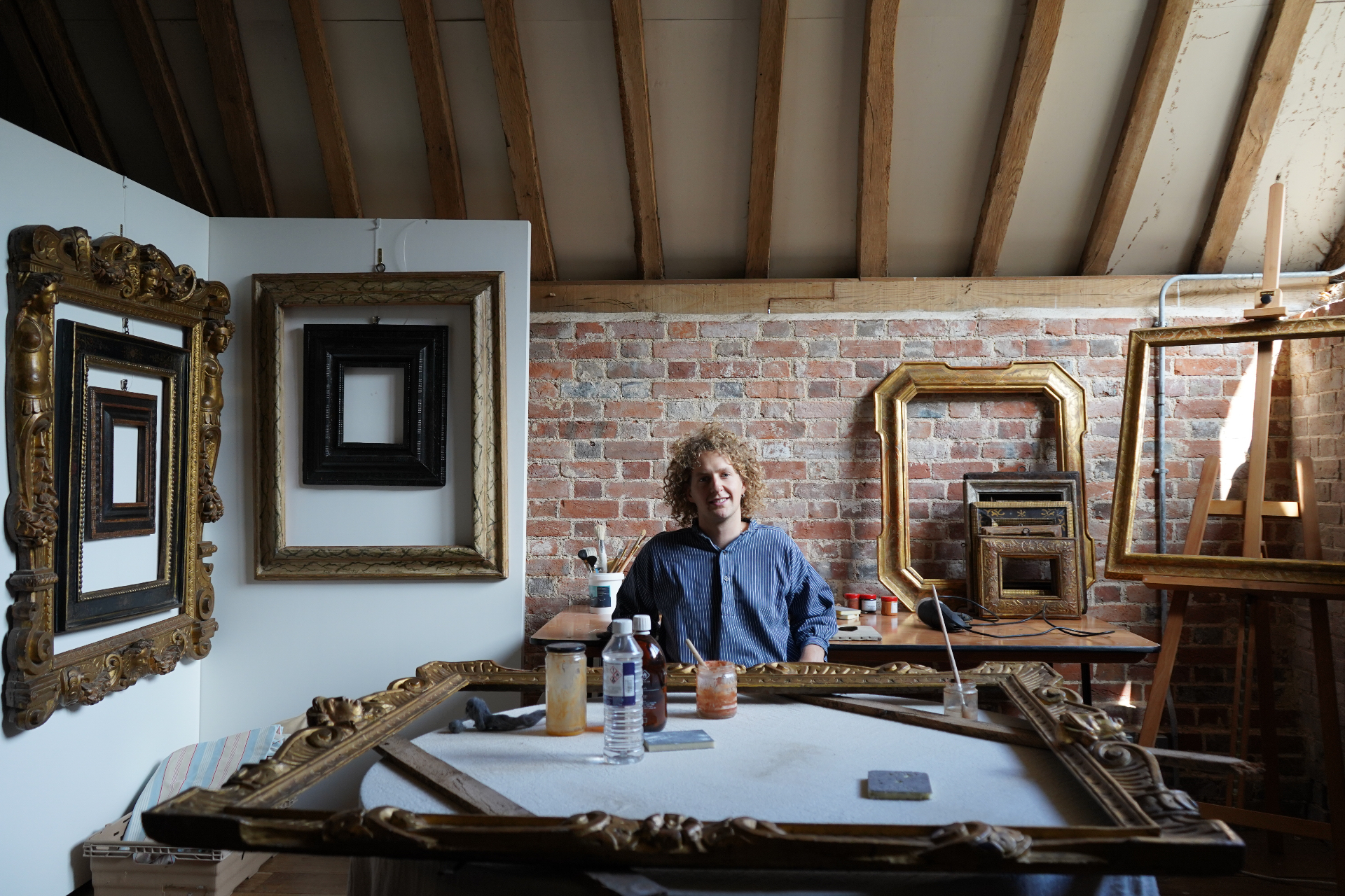Heirloom workshop with antique frames and restoration tools